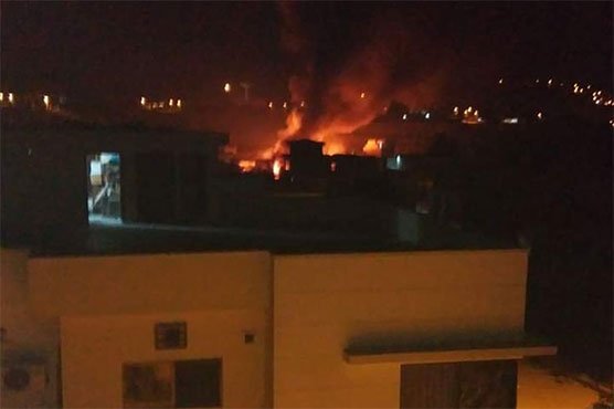 Picture showing the houses engulfed in flames after the Pakistan Army Aviation Aircraft crash landed on 5 residential houses.