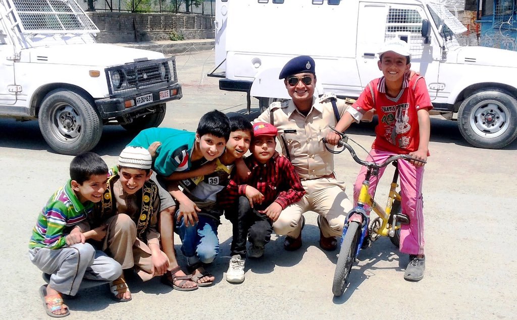 Children chilling around with Police Officer in Kashmir