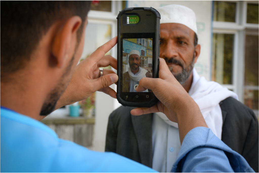 Afghan Election 2019:  An election worker checks a prospective voter, Mohammed Bashir, 54, using a biometric scanner during Afghanistan’s presidential elections 28-Septeber 2019. 