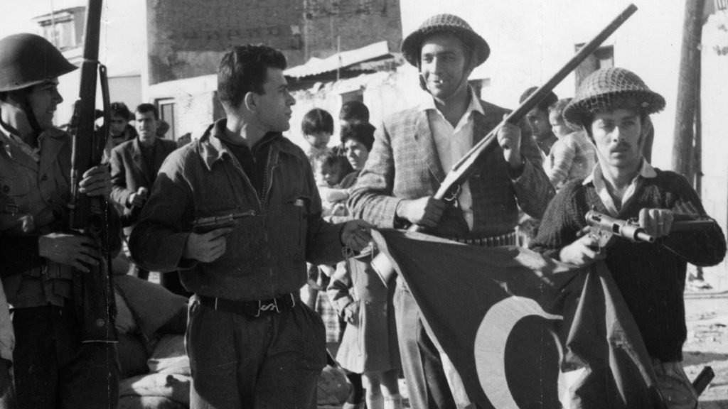 circa 1974:  Former EOKA  terrorist Nikos Sampson leads armed men with a  captured Turkish flag after a Greek Cypriot coup. He later declared himself President.  (Photo by Keystone/Getty Images)